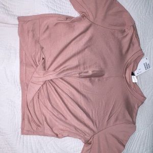 Unused H&M pink medium shirt with twist at bottom.